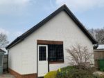 Black bargeboards and soffits on a white garage