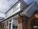 White fascias, soffits, black guttering and Hardie Plank cladding