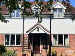 New white fascia, soffits and black guttering on a detached house