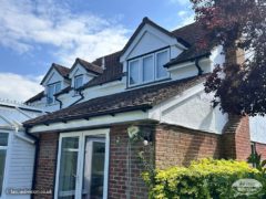 New white fascia, soffits and black guttering on upper and lower levels of detached house