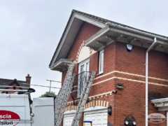 Detached house with decorative roofline features before replacement