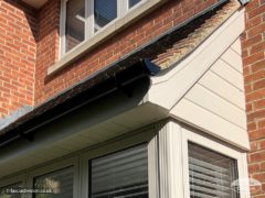 Cream cladding, fascia and soffit with black guttering on bay window