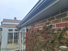 Black continuous guttering with agate grey fascias and soffits