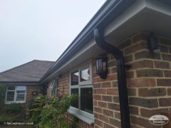 Black continuous guttering with UPVC agate grey fascias and soffits