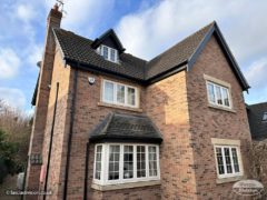 Black ash fascia and soffit with black guttering detached house